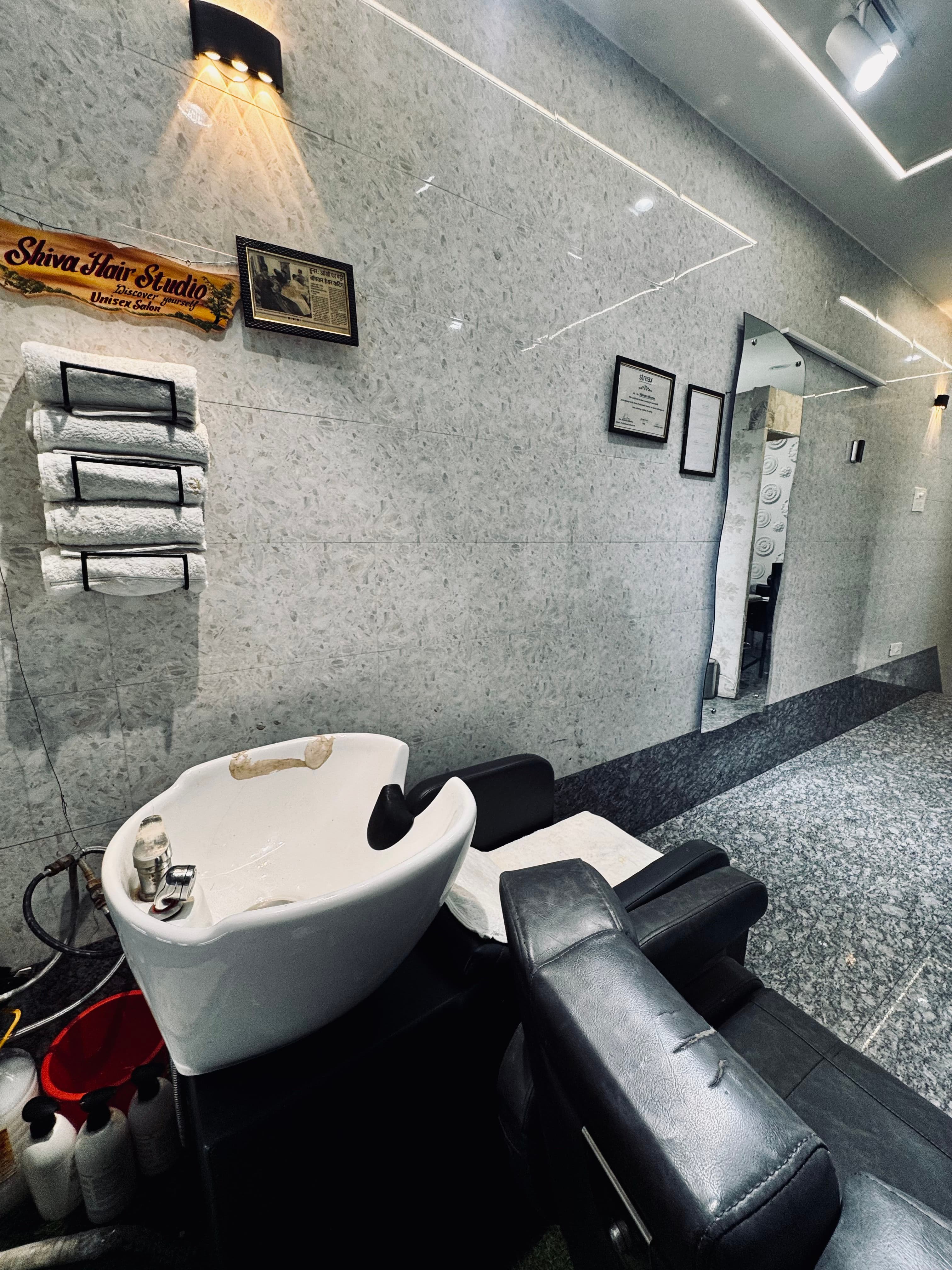 Wash basin and service area at Shiva Hair Studio.